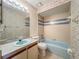 Bathroom with updated vanity and shower/tub combo at 9835 Lakeshore Dr, Clermont, FL 34711