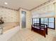Bathroom with a bathtub, shower, and tiled floor at 9835 Lakeshore Dr, Clermont, FL 34711