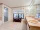 Bathroom with double sinks, a shower, and a tiled floor at 9835 Lakeshore Dr, Clermont, FL 34711