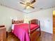 Bedroom with hardwood floors and a wooden four-poster bed at 9835 Lakeshore Dr, Clermont, FL 34711