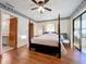 Spacious bedroom with a post bed, wood floors and access to a balcony at 9835 Lakeshore Dr, Clermont, FL 34711