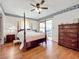 Bedroom with hardwood floors and private balcony access at 9835 Lakeshore Dr, Clermont, FL 34711