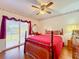 Main bedroom with private access to balcony and pool view at 9835 Lakeshore Dr, Clermont, FL 34711
