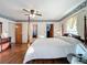 Bright bedroom with a post bed, wood floors and access to other rooms at 9835 Lakeshore Dr, Clermont, FL 34711