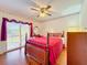 Bedroom with hardwood floors and a wooden four-poster bed at 9835 Lakeshore Dr, Clermont, FL 34711
