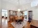 Charming dining room featuring hardwood floors, a wooden table, and built-in hutch at 9835 Lakeshore Dr, Clermont, FL 34711