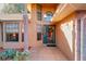 Inviting house exterior featuring a brick facade, landscaped yard, and a covered entryway at 9835 Lakeshore Dr, Clermont, FL 34711