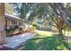 House exterior showcasing a patio, lawn, and trees at 9835 Lakeshore Dr, Clermont, FL 34711