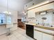 Kitchen with breakfast bar and view to living room at 9835 Lakeshore Dr, Clermont, FL 34711