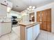 Kitchen with island and stainless steel appliances at 9835 Lakeshore Dr, Clermont, FL 34711