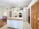 White kitchen with ample counter space and island at 9835 Lakeshore Dr, Clermont, FL 34711