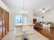 Bright kitchen features a breakfast bar and access to a screened porch at 9835 Lakeshore Dr, Clermont, FL 34711