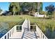 Lake access with a wooden dock and lily pads at 9835 Lakeshore Dr, Clermont, FL 34711