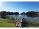Private wooden dock extending over calm lake water at 9835 Lakeshore Dr, Clermont, FL 34711