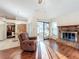 Relaxing living room with hardwood floors and fireplace at 9835 Lakeshore Dr, Clermont, FL 34711
