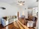 Living room featuring hardwood floors and ample natural light at 9835 Lakeshore Dr, Clermont, FL 34711