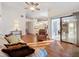 Open living room showcasing hardwood floors and access to kitchen and dining areas at 9835 Lakeshore Dr, Clermont, FL 34711