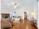 Living room with hardwood floors and brick fireplace at 9835 Lakeshore Dr, Clermont, FL 34711