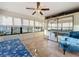 Sunroom featuring tile flooring, mirrored closet, and comfy seating at 9835 Lakeshore Dr, Clermont, FL 34711