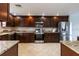 Modern kitchen with dark wood cabinets and granite counters at 1001 Michelle Ct, Tavares, FL 32778