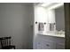 Double vanity bathroom with updated fixtures and cabinetry at 101 Mango Cv, Leesburg, FL 34748