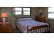 Cozy bedroom with a full-size bed and wooden dresser at 101 Mango Cv, Leesburg, FL 34748