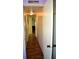 Simple hallway with wood-look flooring and access to rooms at 101 Mango Cv, Leesburg, FL 34748