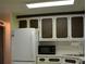 White appliances and dark brown cabinets at 101 Mango Cv, Leesburg, FL 34748