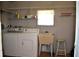 Bright laundry room, washer, dryer, utility sink, and shelving at 101 Mango Cv, Leesburg, FL 34748