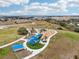 Aerial view of a community playground with walking paths and surrounding landscape at 1115 Calico Pointe Cir, Groveland, FL 34736
