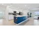 Modern kitchen with island, stainless steel appliances, and blue cabinetry at 1115 Calico Pointe Cir, Groveland, FL 34736