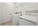 Laundry room with washer, dryer, and overhead shelving at 1115 Calico Pointe Cir, Groveland, FL 34736
