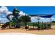 Modern playground with shaded areas and accessible play equipment for children of all ages at 1115 Calico Pointe Cir, Groveland, FL 34736