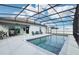 Inviting pool area with covered patio, comfortable seating, and a built-in grill at 1115 Calico Pointe Cir, Groveland, FL 34736