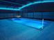 Inviting pool with blue LED lights, screened enclosure, and concrete decking at 1115 Calico Pointe Cir, Groveland, FL 34736