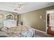 Relaxing bedroom with ceiling fan, white dresser, and floral bedding at 1281 Gray Ct, Eustis, FL 32726