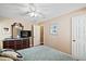 Bedroom with dresser, TV, ceiling fan and window blinds at 1281 Gray Ct, Eustis, FL 32726
