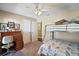 Bedroom with bunk beds, ceiling fan, and a desk at 1281 Gray Ct, Eustis, FL 32726
