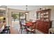 Bright dining room with hardwood floors, oval table, and view of the pool at 1281 Gray Ct, Eustis, FL 32726