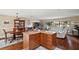 Kitchen island and dining area with hardwood floors and access to living room at 1281 Gray Ct, Eustis, FL 32726