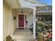 Inviting red front door entryway with porch and landscaping at 1281 Gray Ct, Eustis, FL 32726