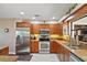 Well-equipped kitchen with stainless steel appliances and wood cabinetry at 1281 Gray Ct, Eustis, FL 32726
