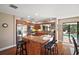 Modern kitchen with granite island, stainless steel appliances, and pool view at 1281 Gray Ct, Eustis, FL 32726
