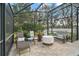 Relaxing screened patio with seating area, fire pit, and outdoor heater at 1281 Gray Ct, Eustis, FL 32726