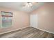 Bedroom with wood-look floors and double-door closet at 12907 Slash Pine Ct, Clermont, FL 34711