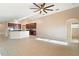 Spacious living room with tile floors and a view of the kitchen at 12907 Slash Pine Ct, Clermont, FL 34711