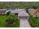 Single-story home with water access and lush landscaping at 13340 Country Club Dr, Tavares, FL 32778