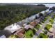 Aerial view of canal front home with boat and dock at 13340 Country Club Dr, Tavares, FL 32778