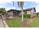 Charming home with a screened patio, deck, and lush landscaping at 13340 Country Club Dr, Tavares, FL 32778