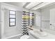 Clean bathroom with shower/tub combo, gray chevron shower curtain, and a vanity with sink at 13340 Country Club Dr, Tavares, FL 32778